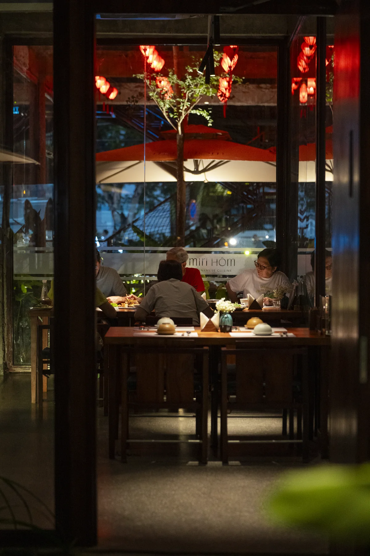 Guests sharing an evening meal in the warmly lit MiRi Hôm dining room