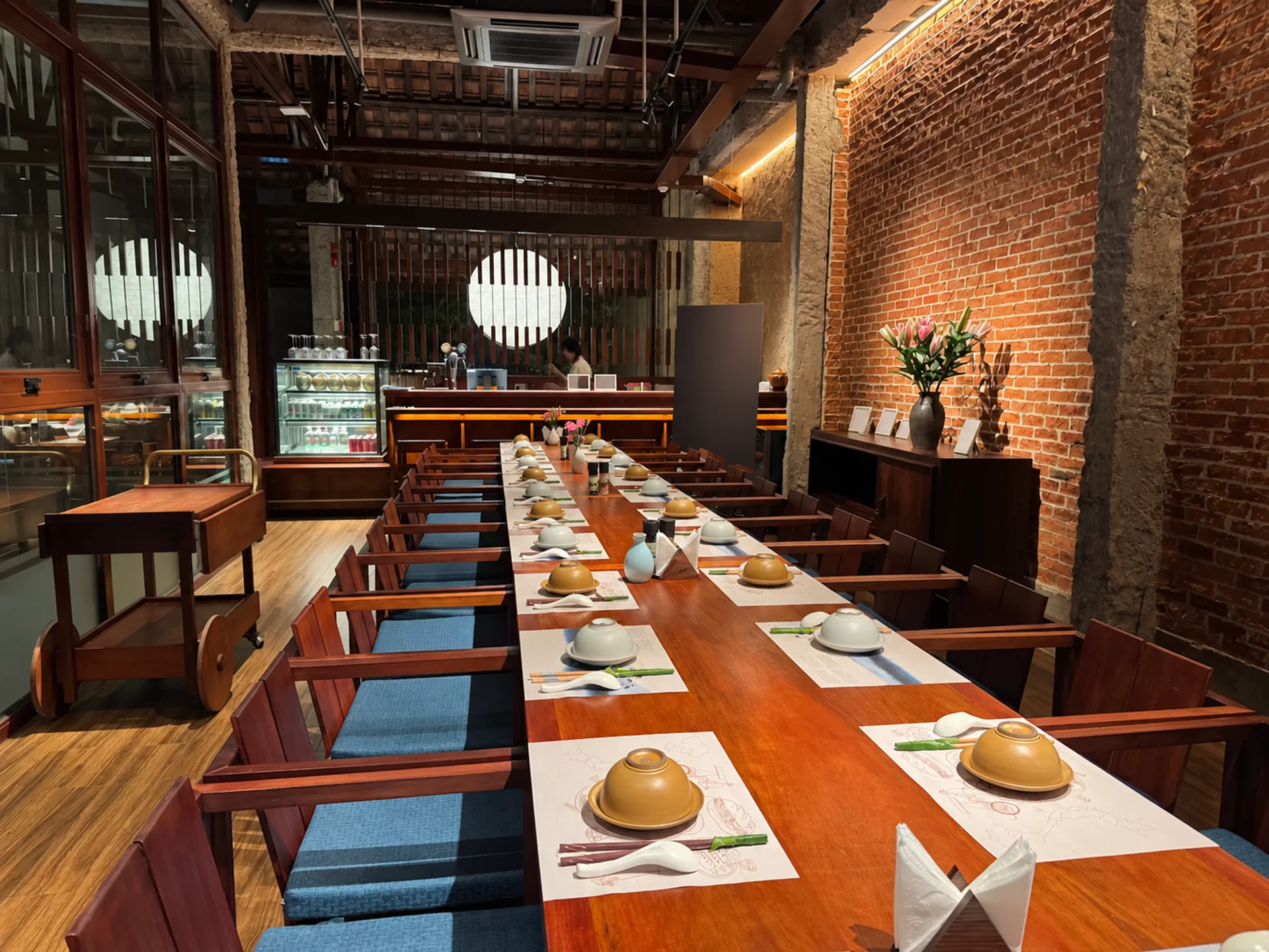 A wide view of the dining room and arranged table settings